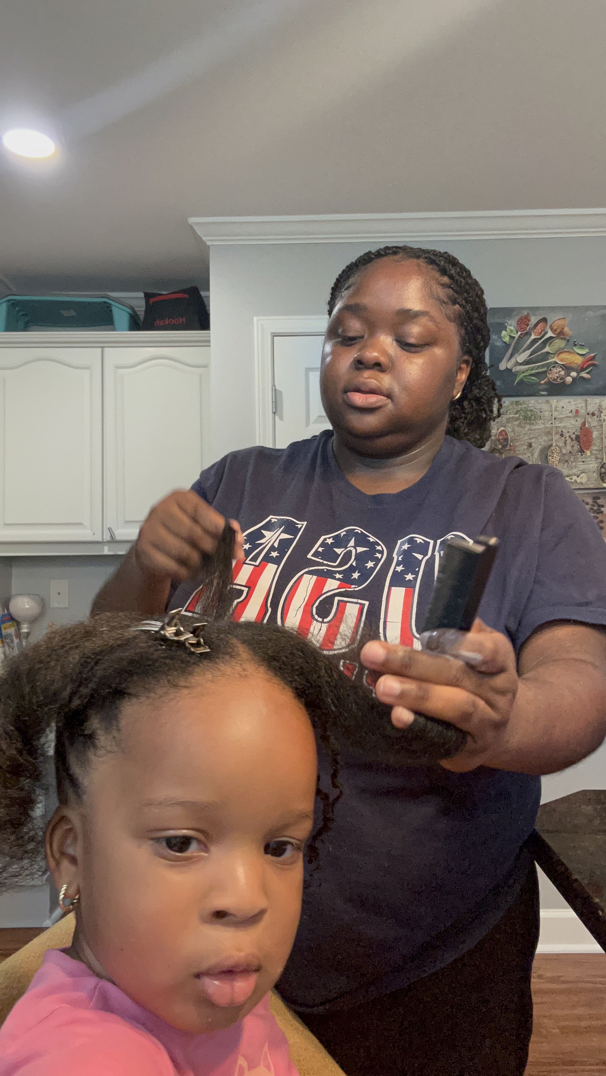 Child receiving natural hair styling