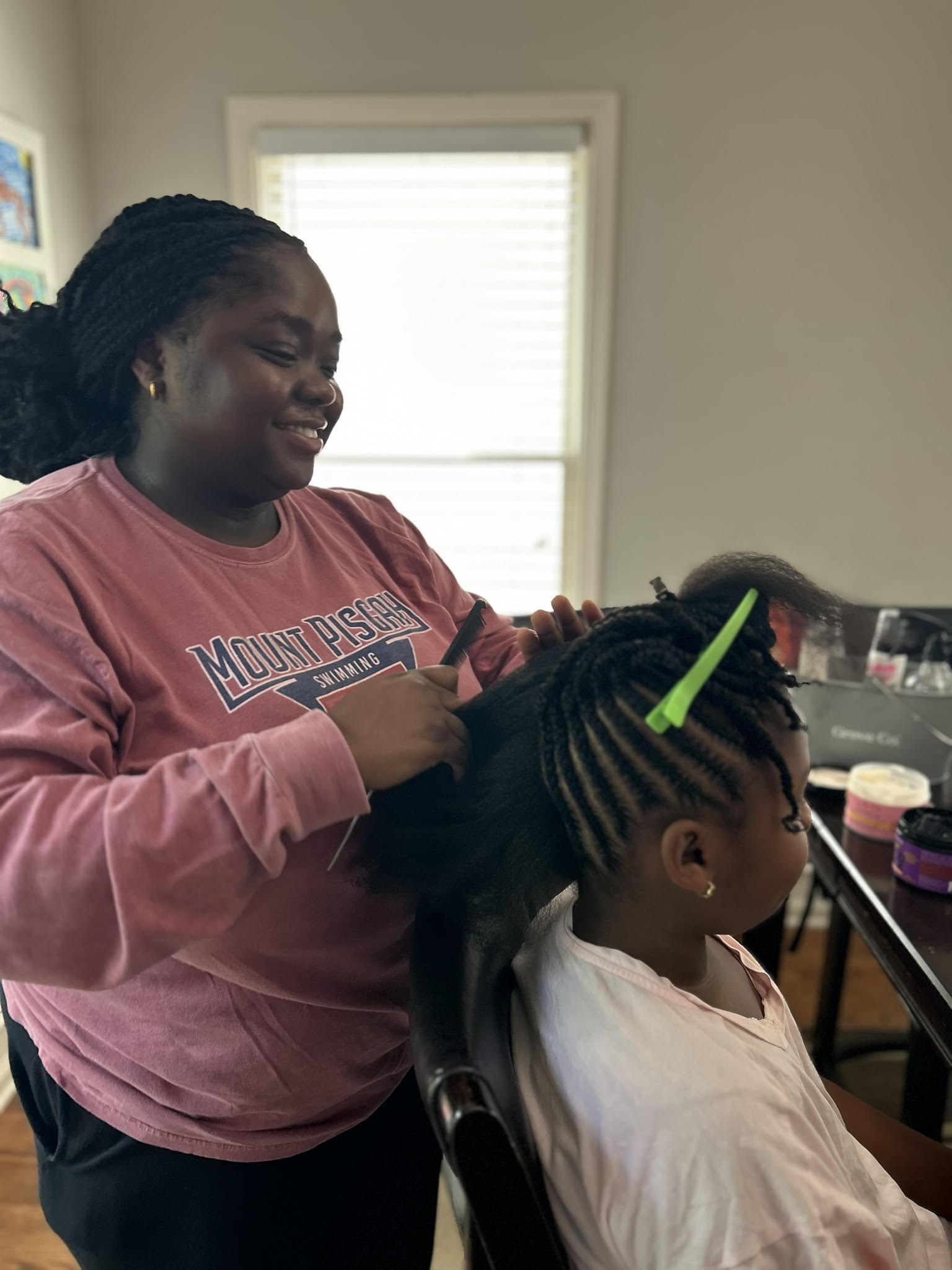 Tumi Owolabi styling a child's natural hair
